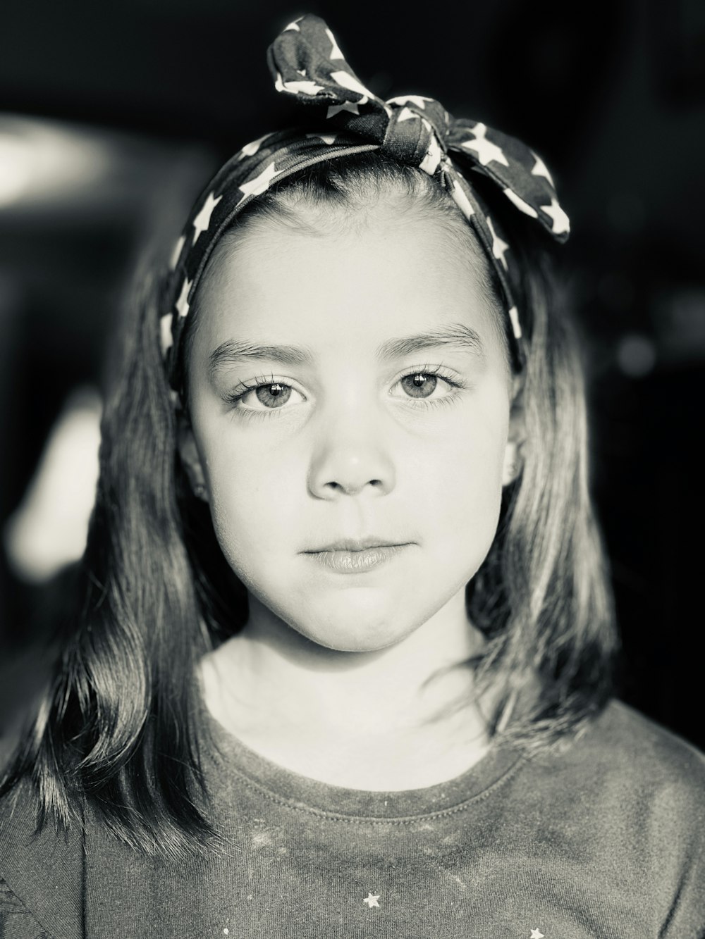 grayscale photo of woman in crew neck shirt with white and black floral headband