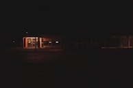 Nighttime exterior shot of a secure building illuminated by soft lighting.