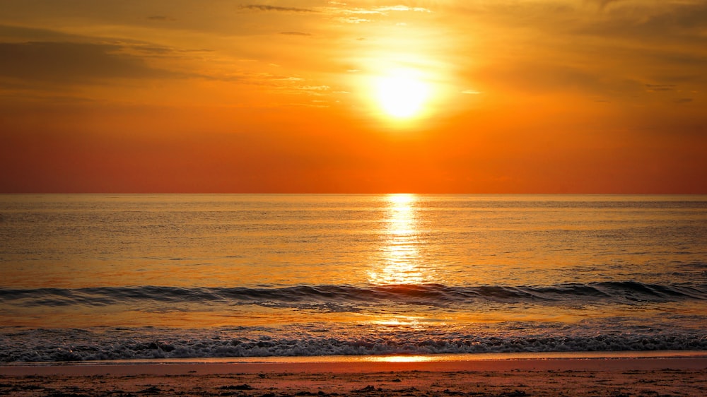 body of water during sunset