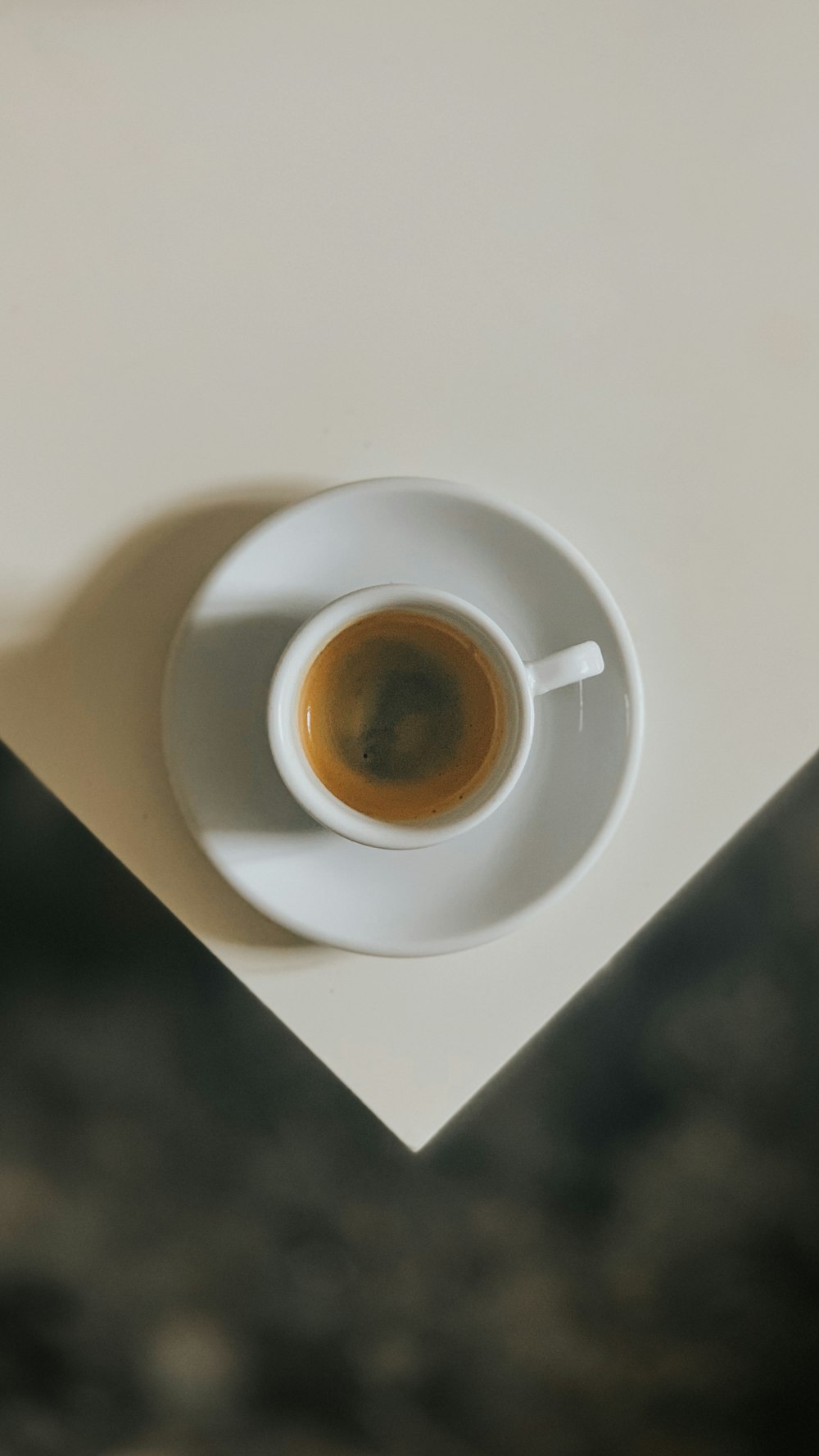 white ceramic cup on white ceramic saucer