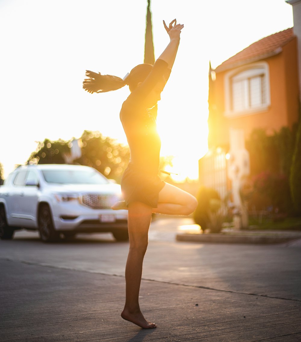 woman in yellow dress standing on road during daytime