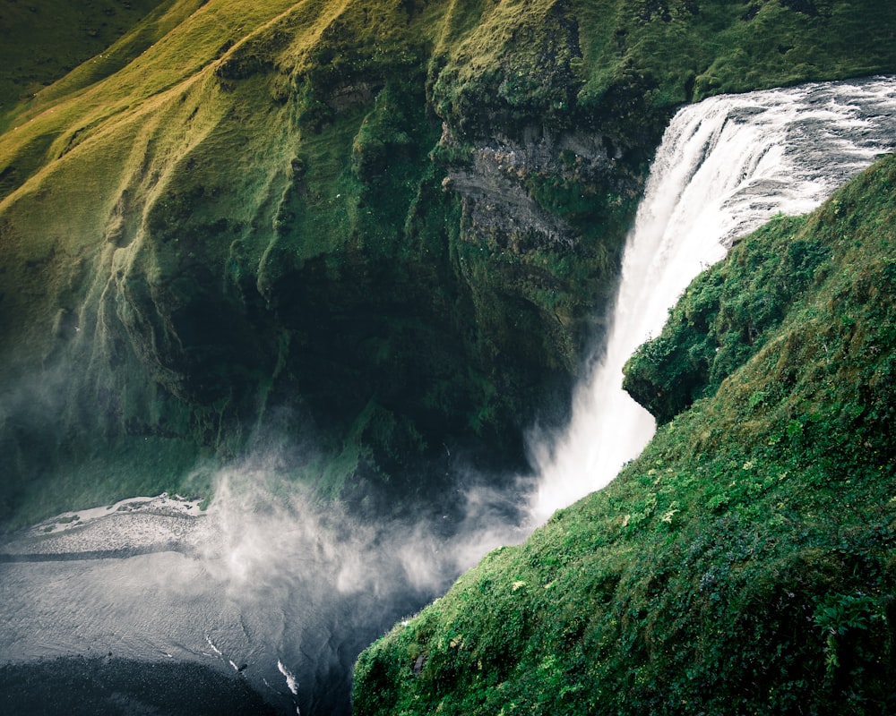 water falls on green mountain