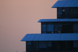 A completed modern building glowing softly at dusk, showcasing thoughtful design.