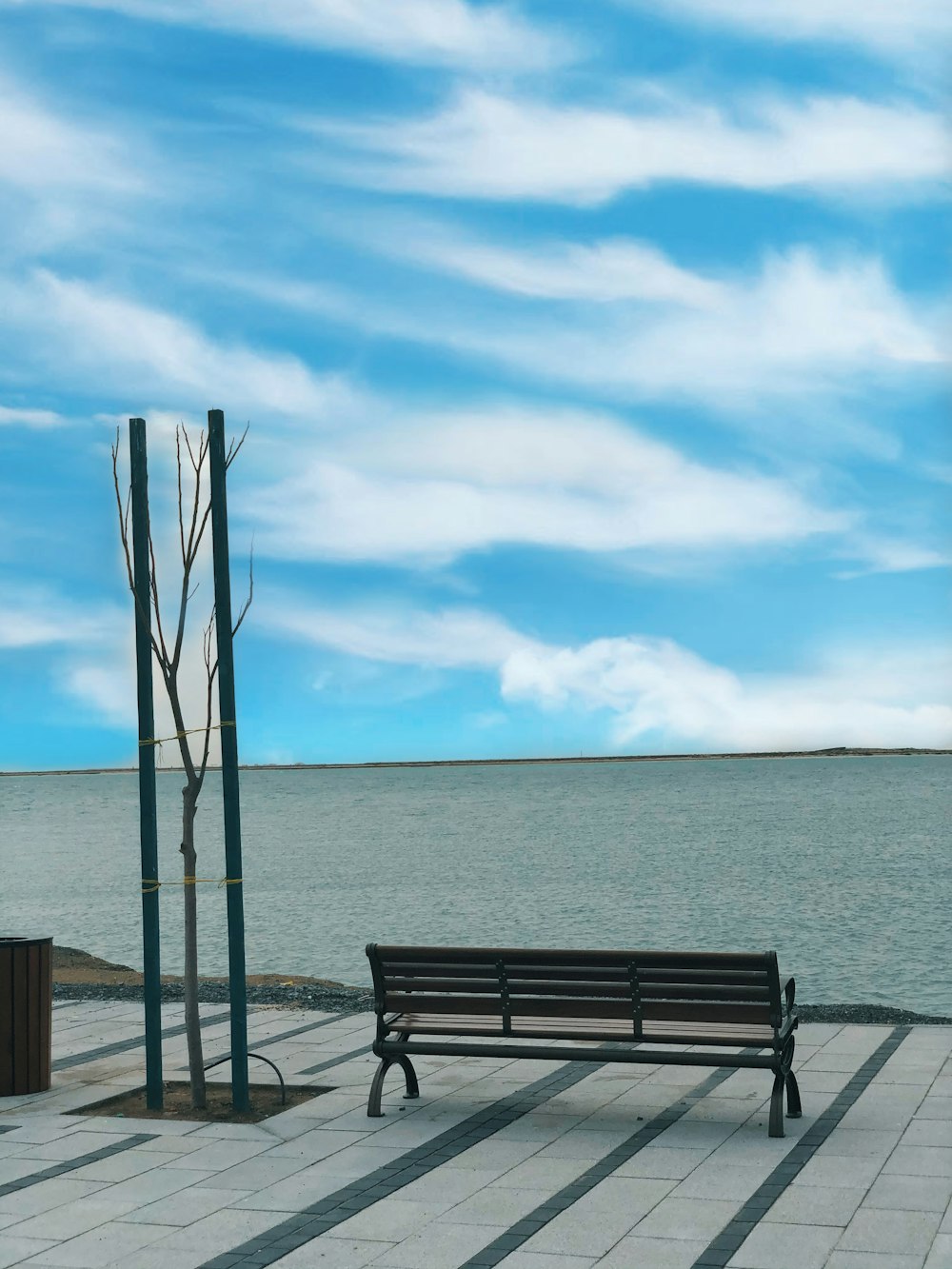 brown wooden bench on beach during daytime