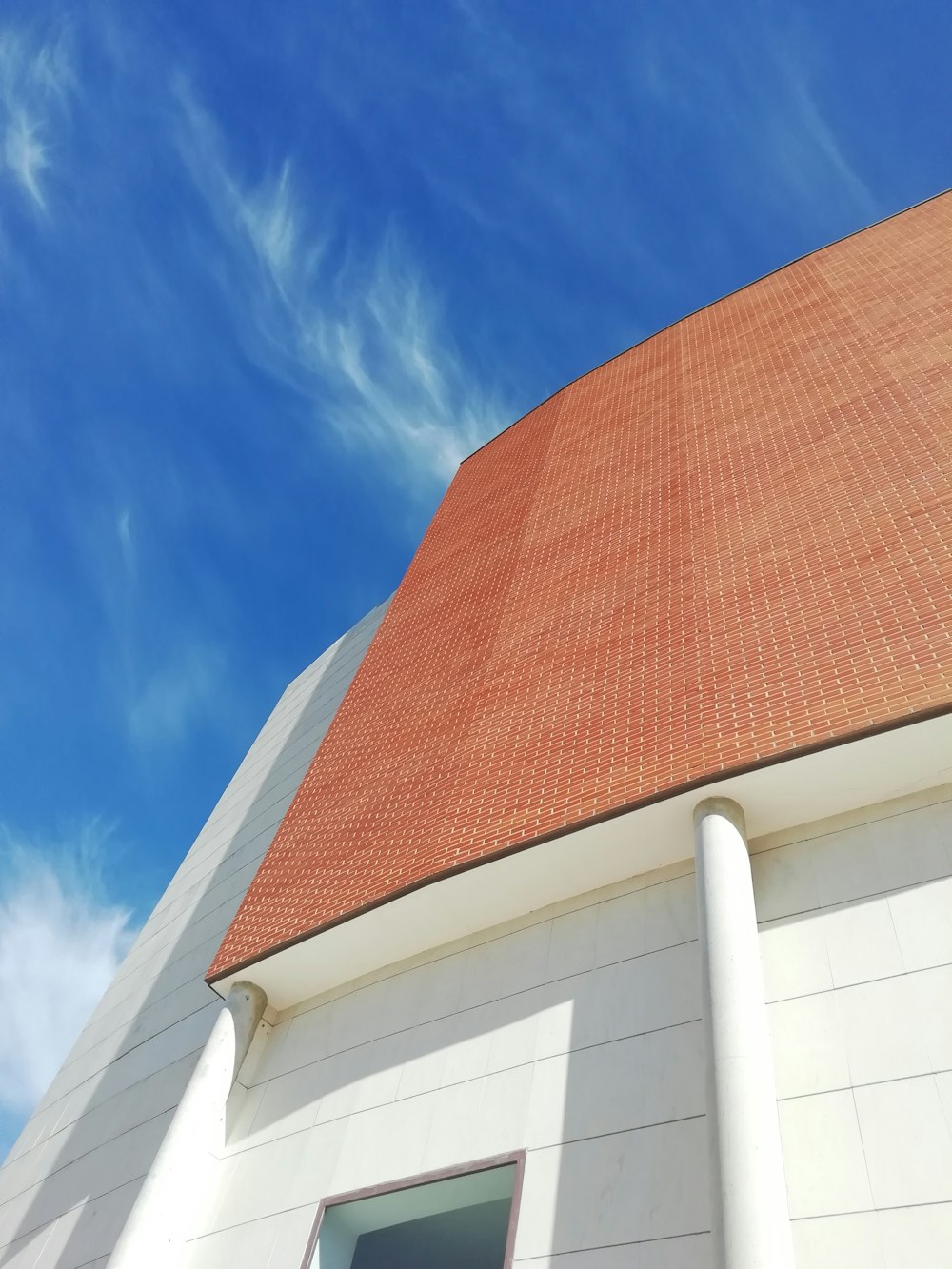 brown and white concrete building under blue sky during daytime