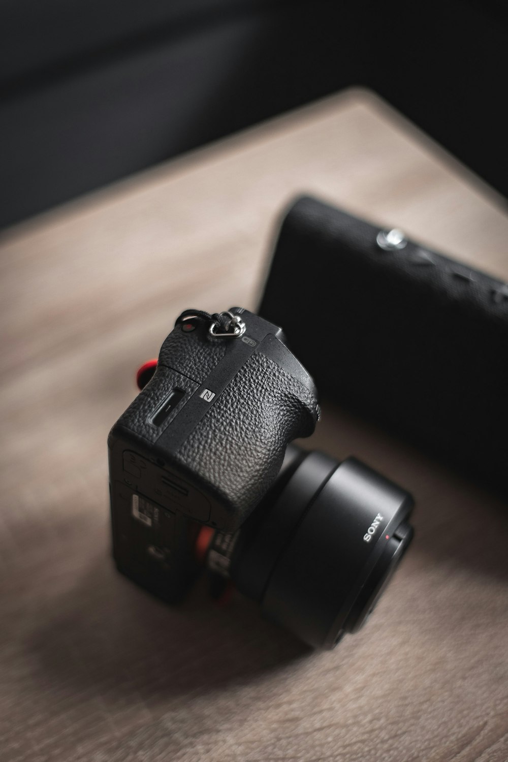 black dslr camera on brown wooden table