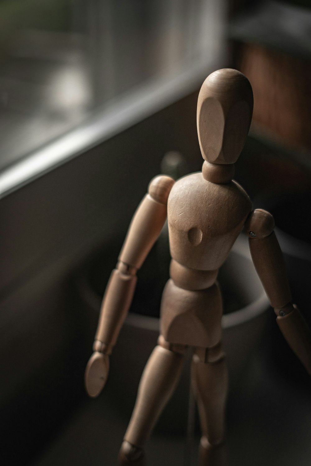 brown wooden human figure on black table