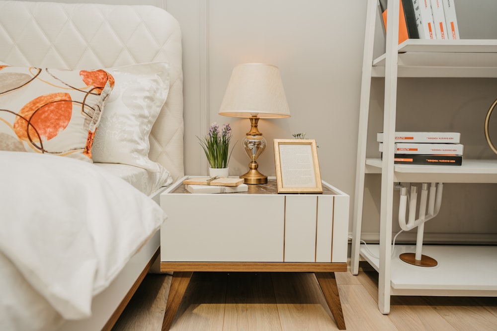 white table lamp on white wooden nightstand