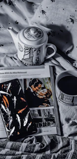 A cozy bedside table with a cup of tea, a book, and the app open on a smartphone screen.