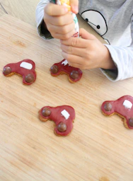 person holding red plastic toy