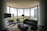 A professional installing carpet in a modern living room.