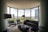 A professional installing carpet in a modern living room.