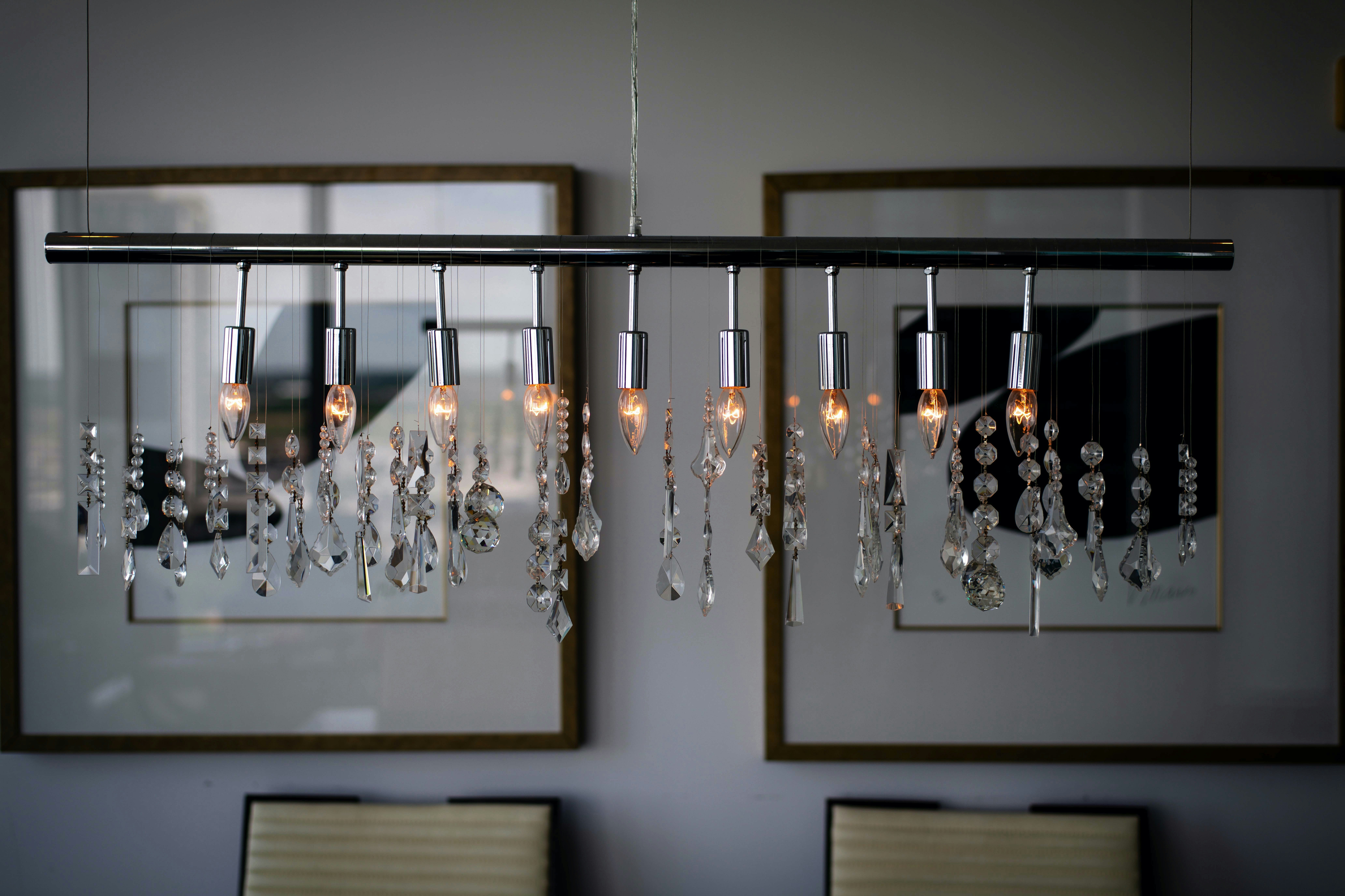 clear glass chandelier turned on inside room