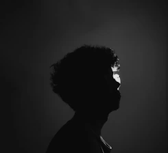 A silhouette of a person with contrasting light and shadow symbolizing awakening consciousness.