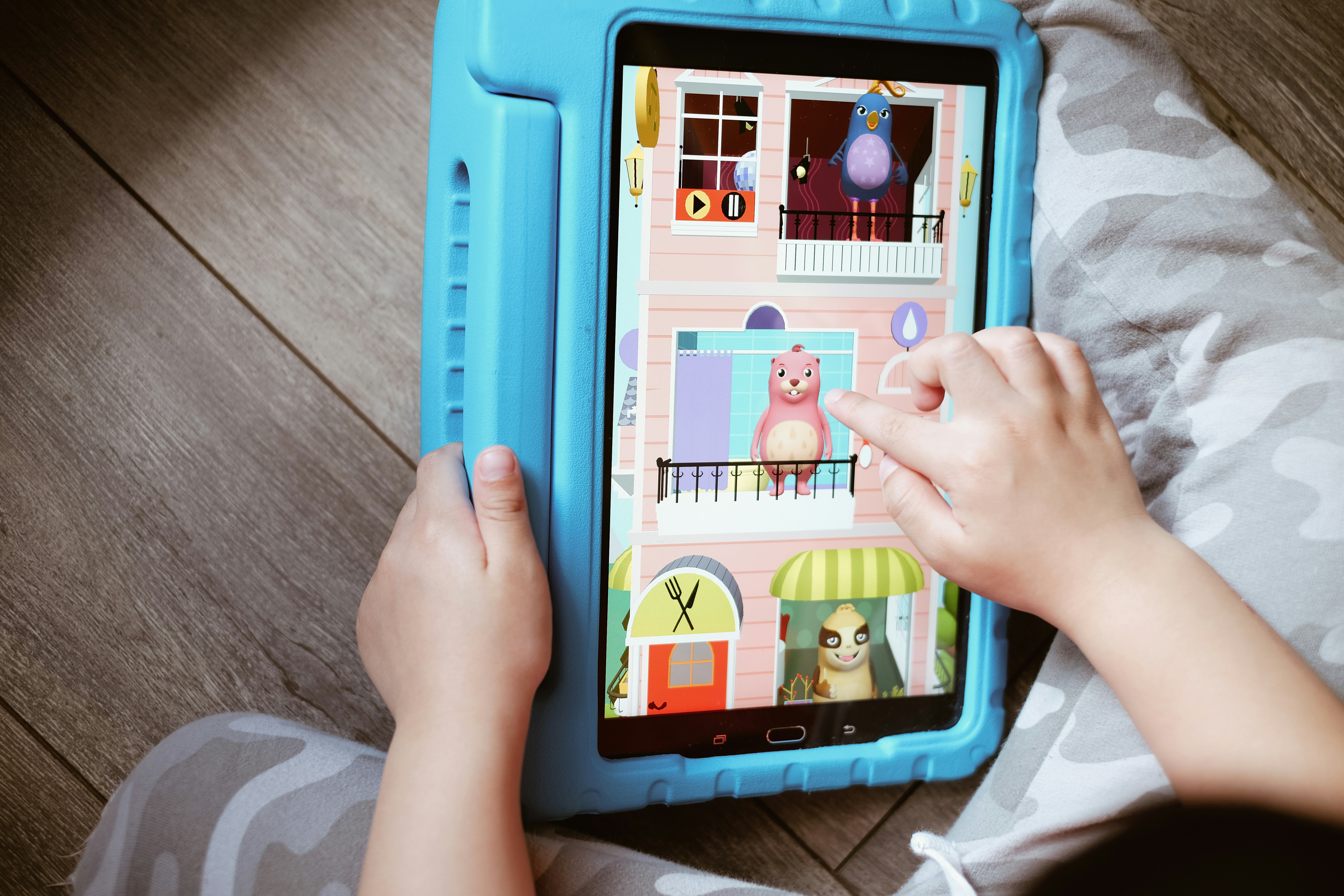 person playing game on tablet computer