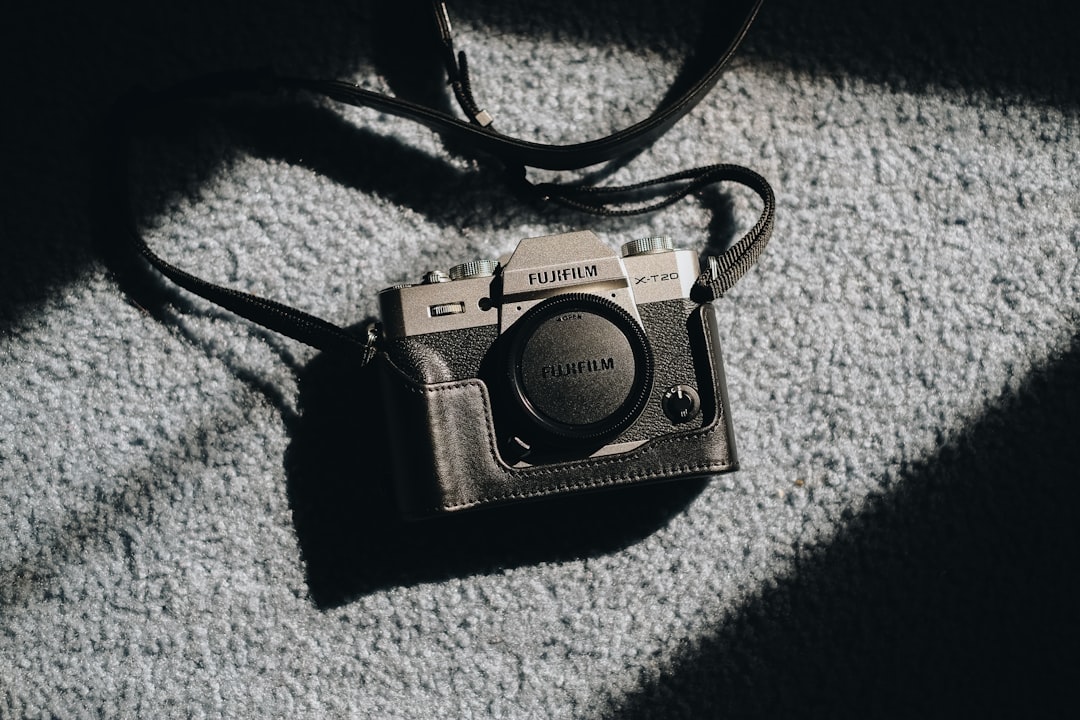 black and silver dslr camera on gray textile