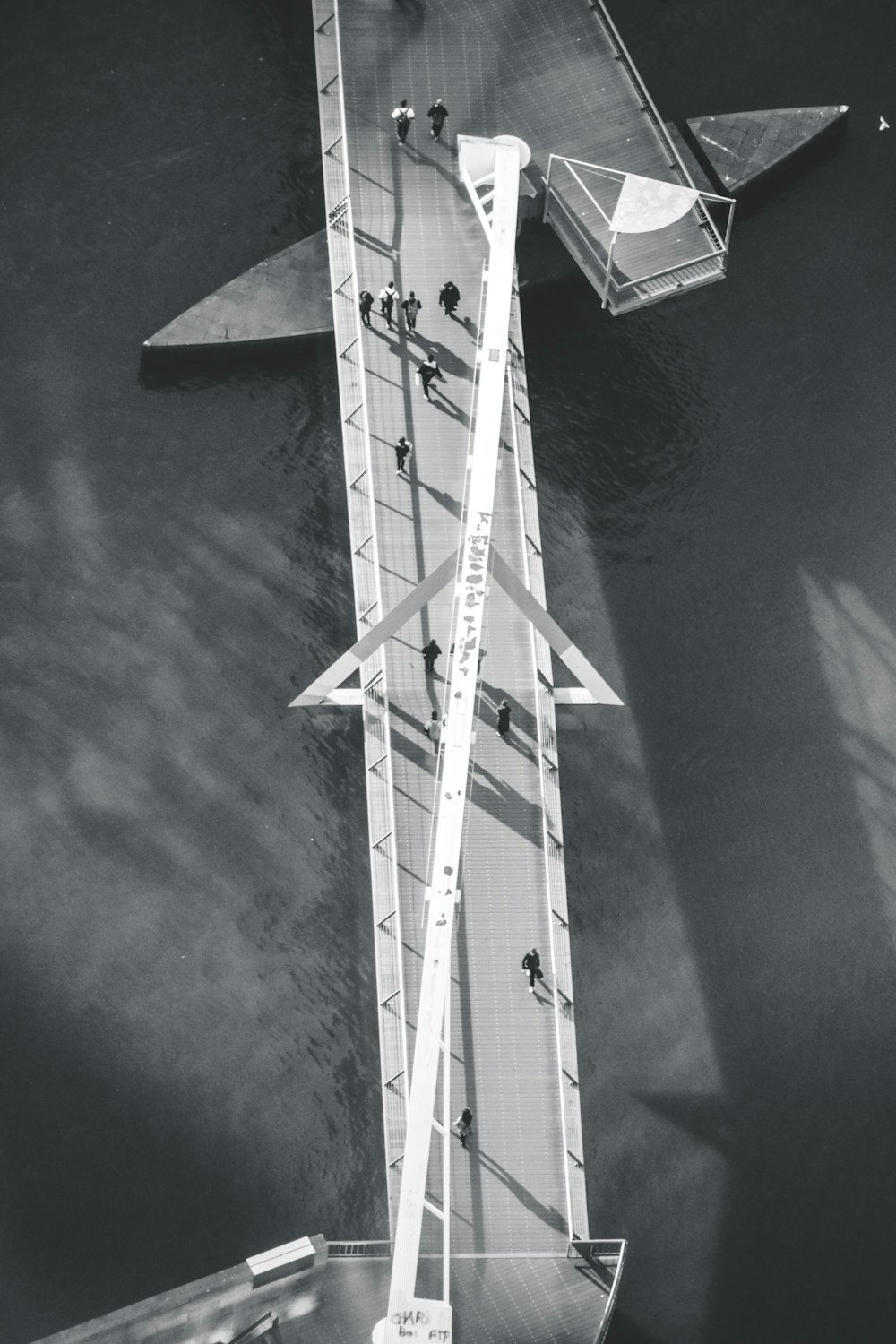 white and black windmill on body of water