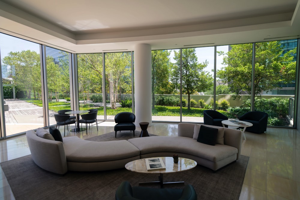 gray sectional couch near glass window