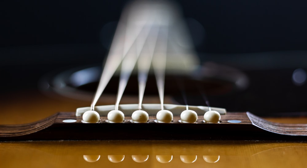 brown guitar head stock in close up photography
