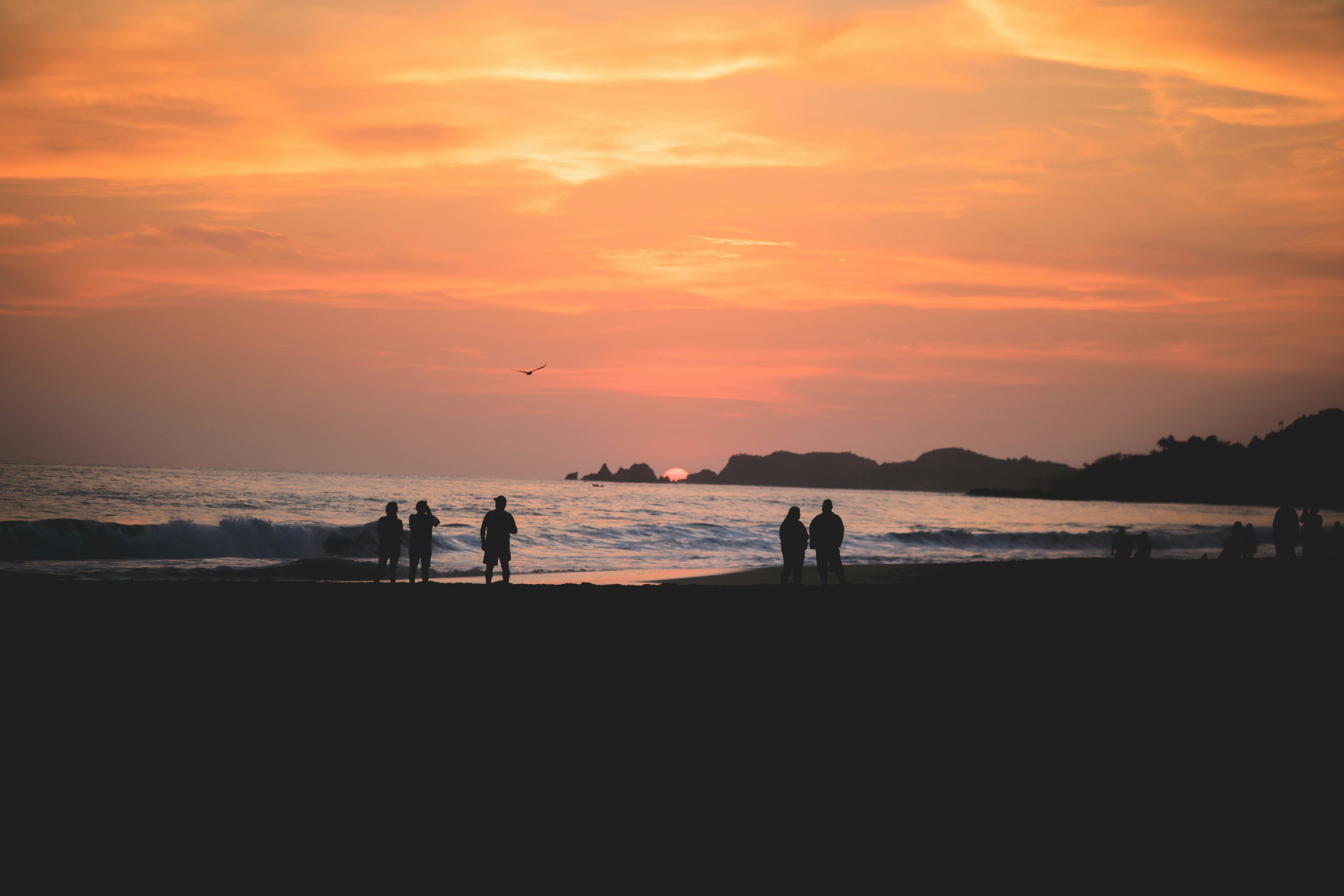 silhouette of people on beach during sunset zihuatanejo zoom background