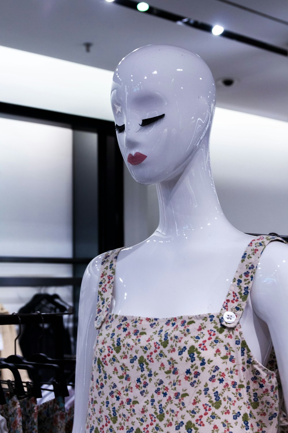 mannequin in white red and green floral tank top