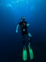 man in black and green wet suit in water