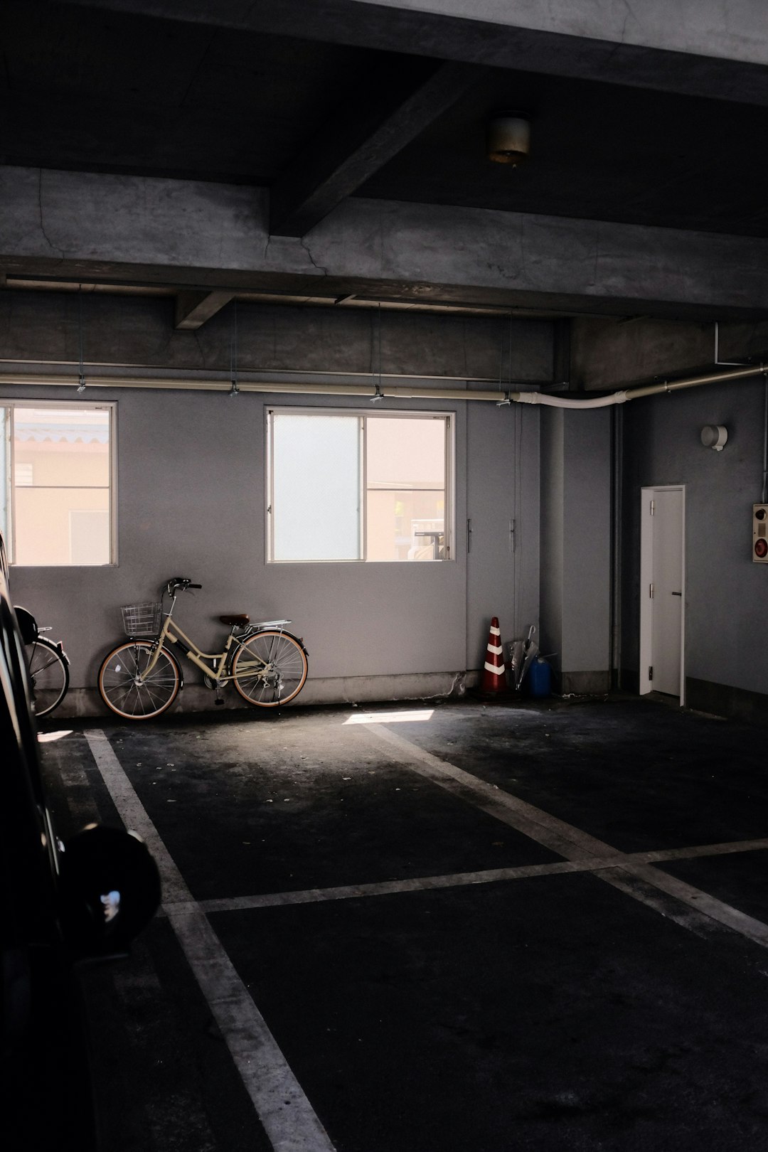 black bicycle parked beside white wooden door