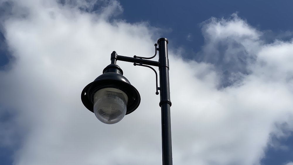 black and silver street light under blue sky