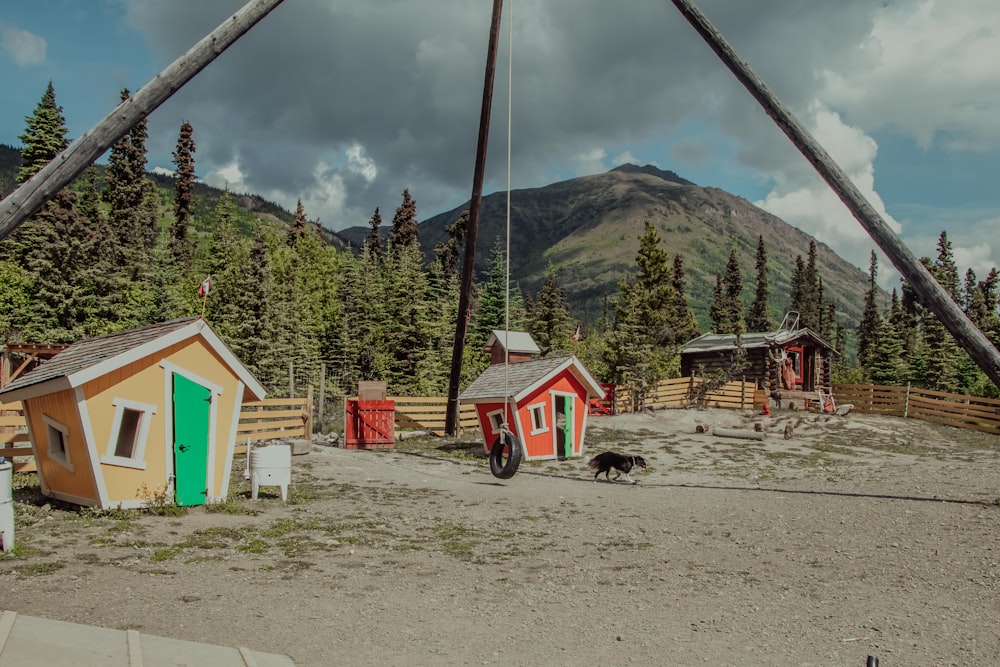 red and white house near green trees and mountain during daytime