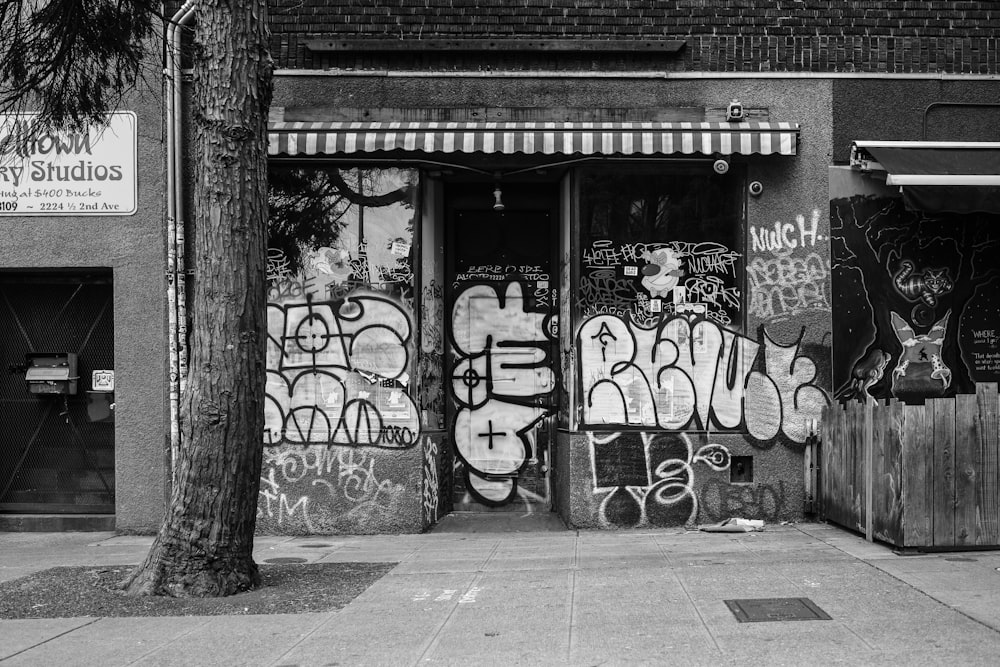 grayscale photo of graffiti on wall