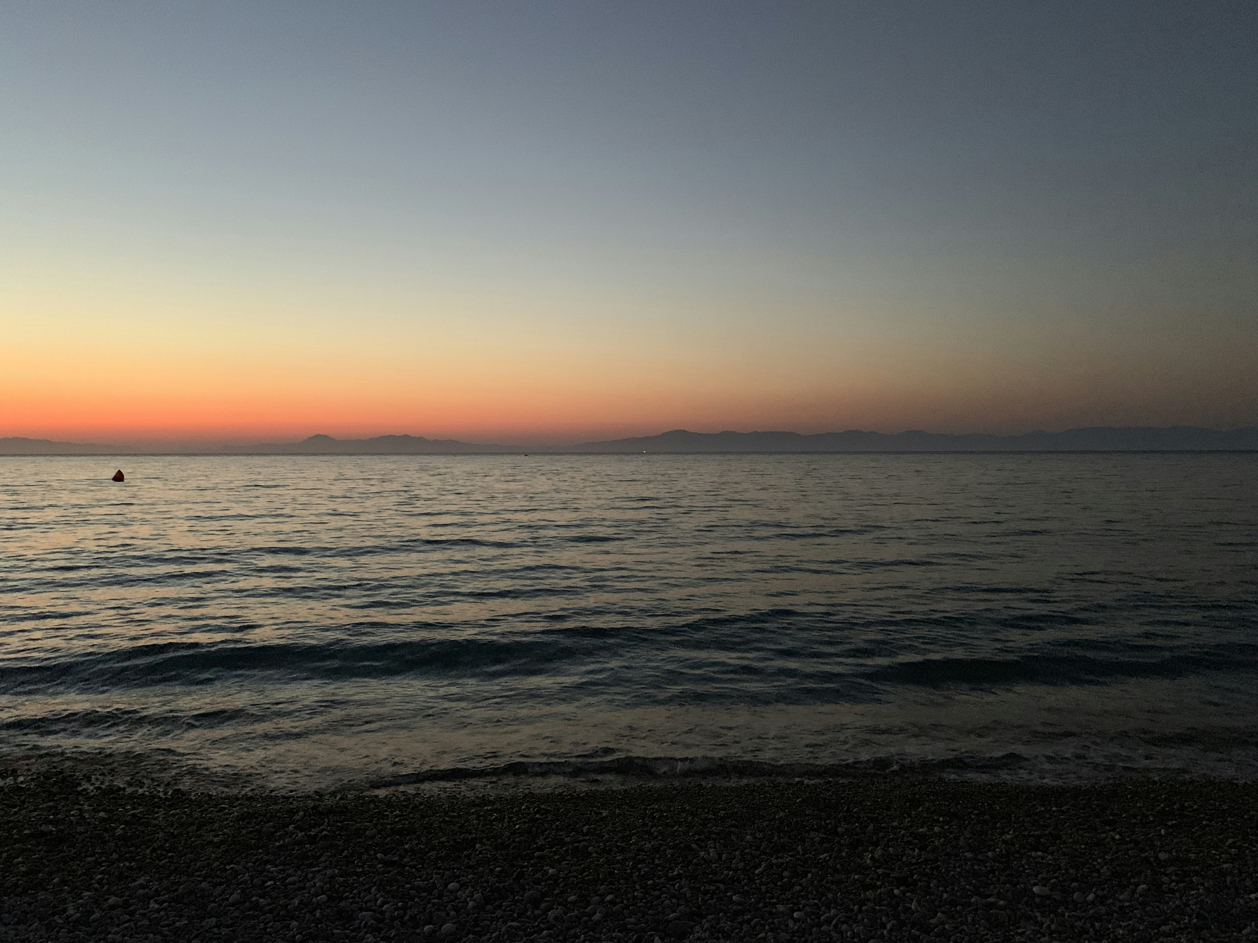 A serene ocean view at dusk, with deep blue waves.