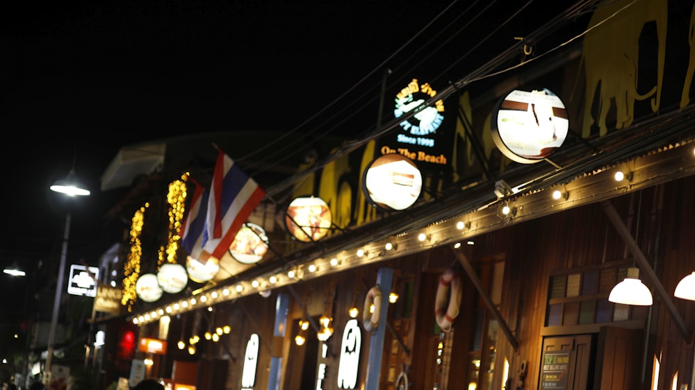 flags on brown wooden fence during nighttime