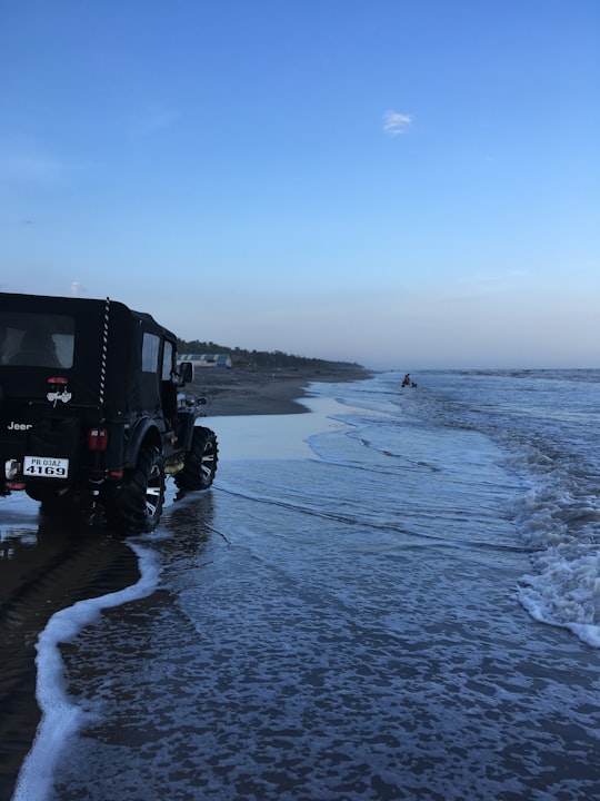 black suv on sea shore during daytime in Mogalthur India