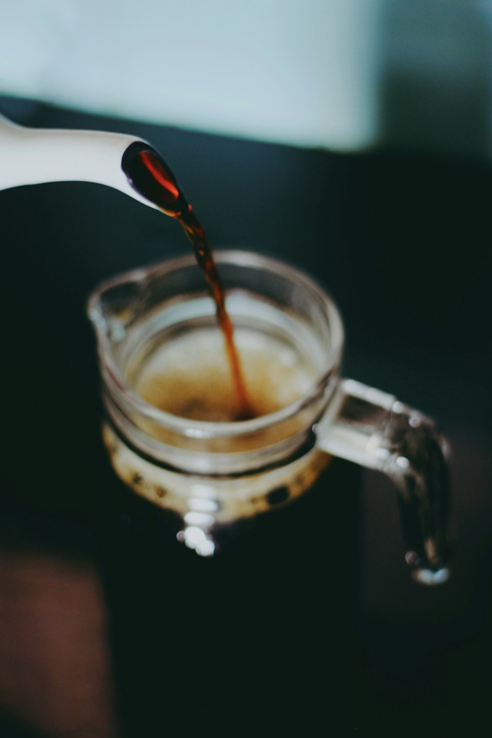 clear glass mug with brown liquid