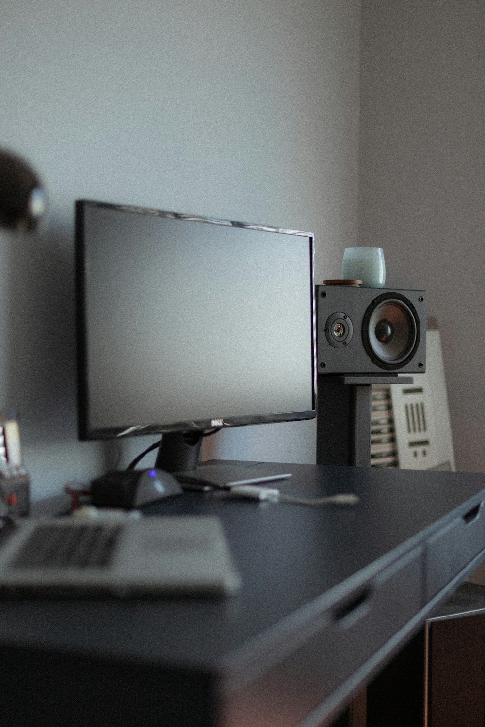 black flat screen computer monitor on black wooden desk