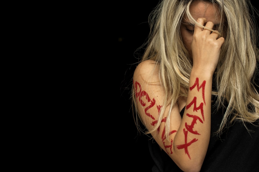 woman with tattoo on her left hand