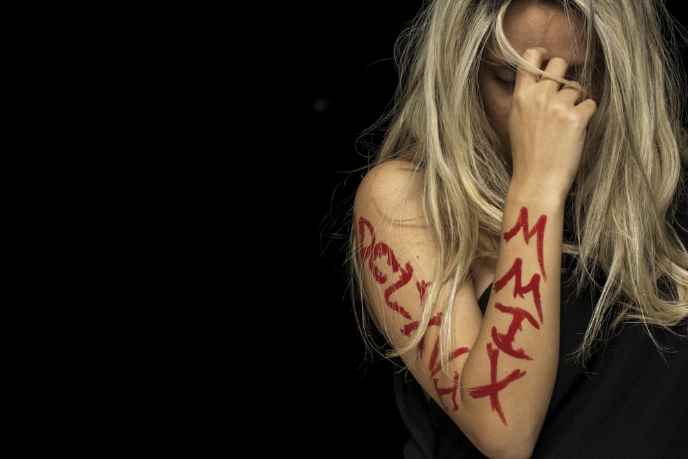 woman with tattoo on her left hand