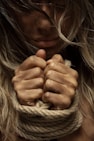 woman with hands tied