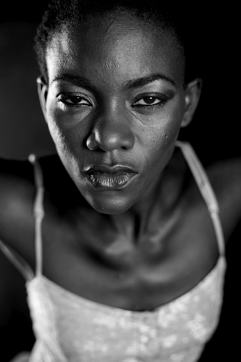 grayscale photo of woman in white tank top