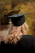 woman wearing academic hat and black academic gown