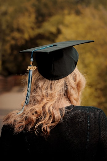 woman wearing academic hat and black academic gown