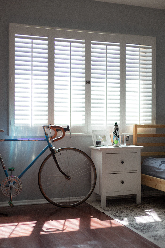 Bifold plantation shutters fitted over a sliding glass door