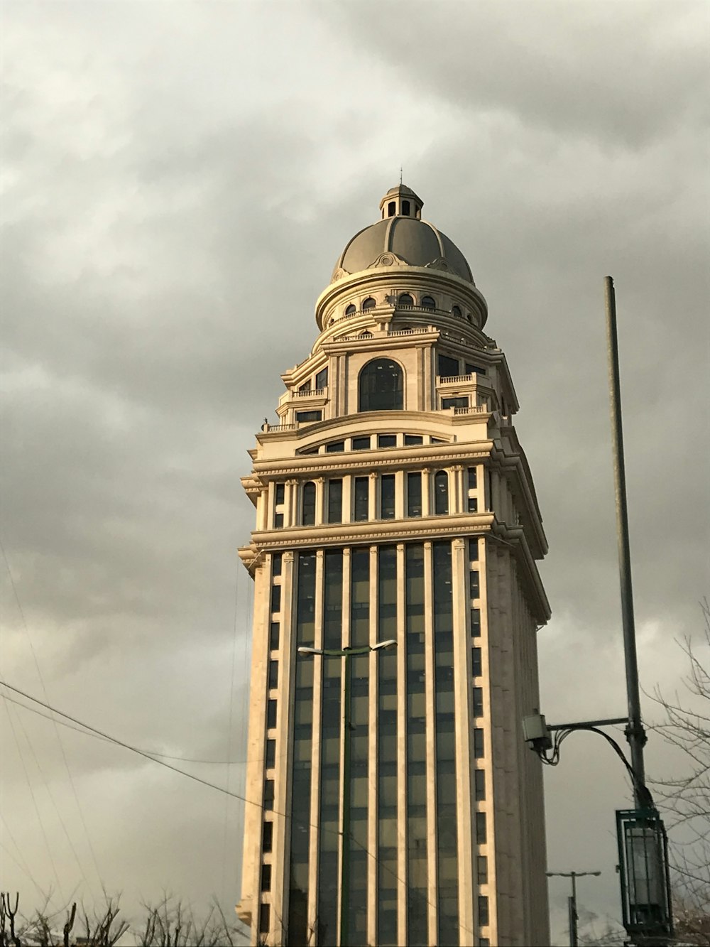 brown concrete building under white clouds during daytime