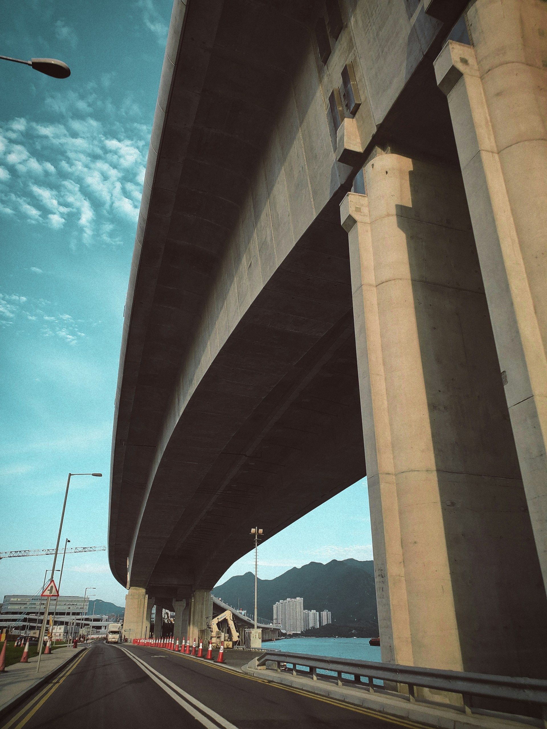 woman wearing yellow long-sleeved dress under white clouds and blue sky during daytime