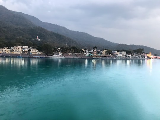 body of water near mountain during daytime in Haridwar India