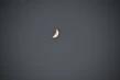 A serene sticker showing a crescent moon with stars and spiritual symbols on white