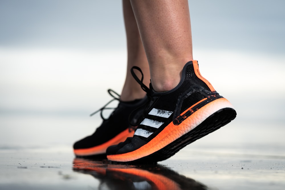 Foto persona con zapatos deportivos nike negros, naranjas y blancos –  Imagen Aarhus gratis en Unsplash