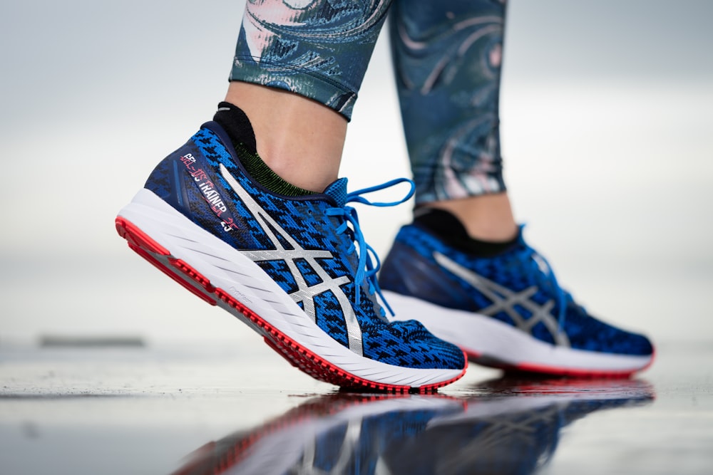 person wearing blue white and red nike athletic shoes photo – Free Image on  Unsplash