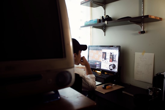 Portrait of Gabriela Cordero Fernandez working at her desk with data charts on a computer screen.
