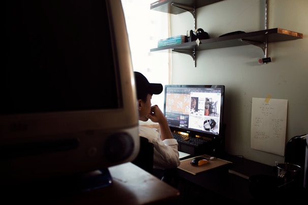 Portrait of Md Jibon Mahmud working intently at his computer with data charts on screen.